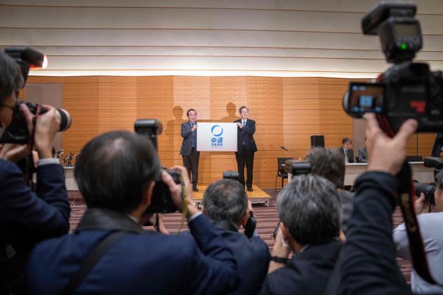 Leader of the Constitutional Democratic Party of Japan (CDP) Yoshihiko Noda (L) and Komeito leader Tetsuo Saito pose during a joint press conference to announce the new party name 'Centrist Reform Alliance' in Tokyo on January 16, 2026. (Photo by Yuichi YAMAZAKI / AFP)