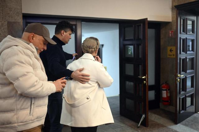 Former Ukraine's Prime Minister Yulia Tymoshenko (R) accompanied by her husband Oleksandr (L) arrives for a pre-trial hearing at a court in Kyiv on January 16, 2026, amid the Russian invasion of Ukraine. Former Ukraine's Prime Minister Yulia Tymoshenko said on January 14, 2026 her party's office had been raided overnight after anti-corruption bodies announced a sweeping probe into political corruption. (Photo by Sergei GAPON / AFP)