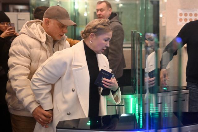 Former Ukraine's Prime Minister Yulia Tymoshenko accompanied by her husband Oleksandr arrives for a pre-trial hearing at a court in Kyiv on January 16, 2026, amid the Russian invasion of Ukraine. Former Ukraine's Prime Minister Yulia Tymoshenko said on January 14, 2026 her party's office had been raided overnight after anti-corruption bodies announced a sweeping probe into political corruption. (Photo by Sergei GAPON / AFP)