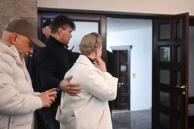 Former Ukraine's Prime Minister Yulia Tymoshenko (R) accompanied by her husband Oleksandr (L) arrives for a pre-trial hearing at a court in Kyiv on January 16, 2026, amid the Russian invasion of Ukraine. Former Ukraine's Prime Minister Yulia Tymoshenko said on January 14, 2026 her party's office had been raided overnight after anti-corruption bodies announced a sweeping probe into political corruption. (Photo by Sergei GAPON / AFP)