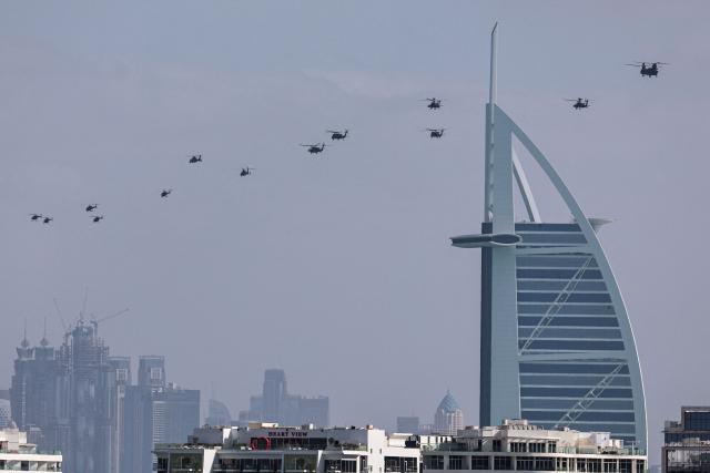 United Arab Emirates army helicopters fly past Burj al Arab hotel, in Dubai on January 16, 2026. (Photo by Fadel SENNA / AFP)