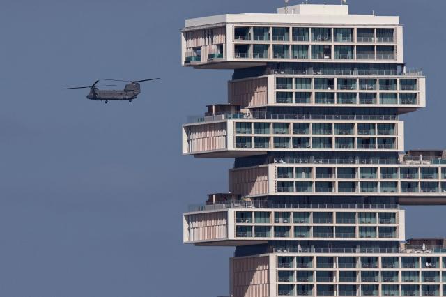 A United Arab Emirates army helicopter, part of a convoy, flies past newly contsructed Atlantis The Royal hotel, in Dubai on January 16, 2026. (Photo by Fadel SENNA / AFP)