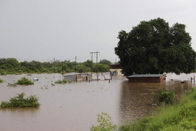 A general view of building and an informal structure submerged in floodwater in Giyani on January 16, 2026. Flooding triggered by torrential rains in northeastern South Africa claimed at least 10 lives overnight and forced the closure of the iconic Kruger National Park, officials said on January 15, 2026. 
The weather service issued the maximum warning for more rain in parts of the country while neighbouring Mozambique was also on alert after flooding that inundated roads and homes. (Photo by Orlando Chauke / AFP)