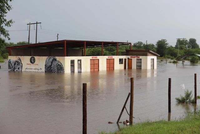 TOPSHOT - A general view of a business premises submerged in floodwater in Giyani on January 16, 2026. Flooding triggered by torrential rains in northeastern South Africa claimed at least 10 lives overnight and forced the closure of the iconic Kruger National Park, officials said on January 15, 2026. 
The weather service issued the maximum warning for more rain in parts of the country while neighbouring Mozambique was also on alert after flooding that inundated roads and homes. (Photo by Orlando Chauke / AFP)