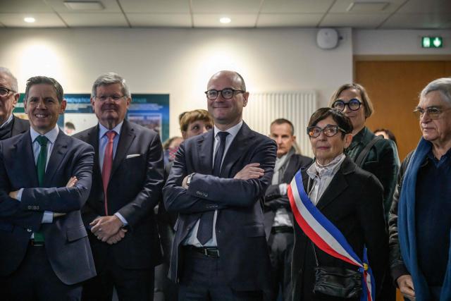France’s junior Minister for industry Sebastien Martin (C), flanked by the mayor of Gaillac Martine Souquet, listens to explanations as he visits the Pierre Fabre Laboratories during an event marking the 'commissioning of the production line for the strategic molecule against cutaneous melanoma', in Gaillac, southern France on January 16, 2026.  (Photo by Ed JONES / AFP)