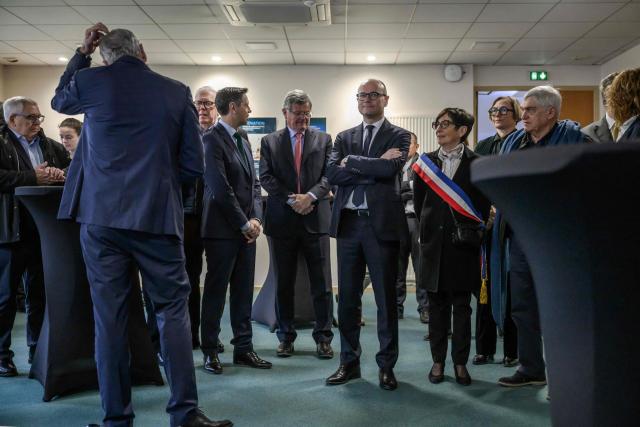 France’s junior Minister for industry Sebastien Martin (C), flanked by the mayor of Gaillac Martine Souquet, listens to explanations as he visits the Pierre Fabre Laboratories during an event marking the 'commissioning of the production line for the strategic molecule against cutaneous melanoma', in Gaillac, southern France on January 16, 2026.  (Photo by Ed JONES / AFP)