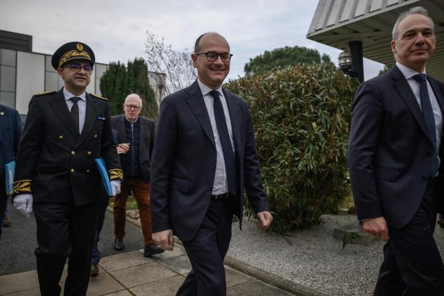 France’s junior Minister for industry Sebastien Martin (C) arrives to visit the Pierre Fabre Laboratories during an event marking the 'commissioning of the production line for the strategic molecule against cutaneous melanoma', in Gaillac, southern France on January 16, 2026.  (Photo by Ed JONES / AFP)