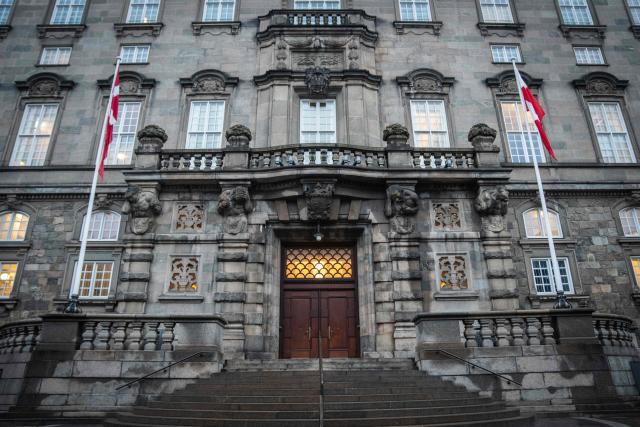 The Greenlandic flag called "Erfalasorput" (R) and the Danish national flag (L) flutter next to the main entrance of the Danish Parliament, Christiansborg, in Copenhagen, Denmark, on January 16, 2026. A meeting of Greenlandic, Danish, and US politicians is scheduled on January 16, 2026. (Photo by Sebastian Elias Uth / Ritzau Scanpix / AFP) / Denmark OUT