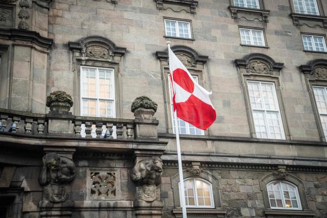 The Greenlandic flag called "Erfalasorput" flutters next to the main entrance of the Danish Parliament, Christiansborg, in Copenhagen, Denmark, on January 16, 2026. A meeting of Greenlandic, Danish, and US politicians is scheduled on January 16, 2026. (Photo by Sebastian Elias Uth / Ritzau Scanpix / AFP) / Denmark OUT