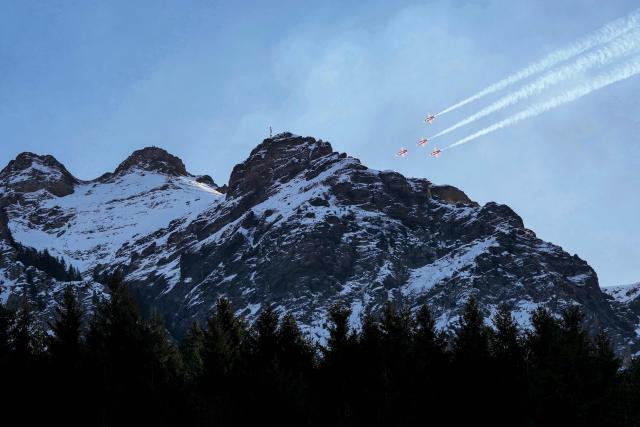 Swiss Air Force's aerobatic team "The Patrouille Suisse" perform prior to the FIS alpine skiing Men's World Cup Super G event in Wengen, Swiss Alps, on January 19, 2026. (Photo by Dimitar DILKOFF / AFP)