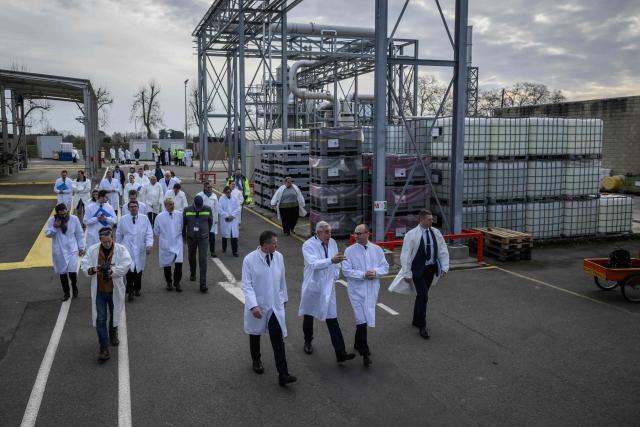 France's junior Minister for industry Sebastien Martin (C) walks with Pierre-Yves Revol (C, L), chairman of Pierre Fabre Participations as he visits the Pierre Fabre Laboratories during an event marking the 'commissioning of the production line for the strategic molecule against cutaneous melanoma', in Gaillac, southern France on January 16, 2026. (Photo by Ed JONES / AFP)