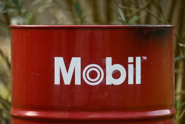 This photograph shows an oil barrel with the branding of US oil giant Exxon Mobil in Itxassou, south-western France on January 16, 2026. The US Department of Energy has unveiled a plan to develop Venezuela's oil industry and has begun marketing Venezuelan crude,with US oil executives meeting with US President Donald Trump ahead of which he pledged to invest $100 billion to revive Venezuela's oil sector. (Photo by Gaizka IROZ / AFP)