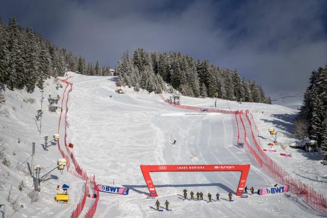 (FILES) Swiss army soldiers remove snow at the arrival area after the women's downhill race was delayed due to snowfall at the FIS Alpine Skiing World Cup in Crans-Montana on January 22, 2021. Officials said January 16, 2026, that three races on the alpine skiing World Cup circuit will go ahead in Crans-Montana despite a fire that killed 40 and injured 119 others celebrating the New Year in the Swiss resort. The organising committee in Crans-Montana, together with FIS and Swiss-Ski, said the January 30-February 1 race schedule would be maintained but with an "adapted format for the suporting events" and all other side events would be cancelled. (Photo by Fabrice COFFRINI / AFP)