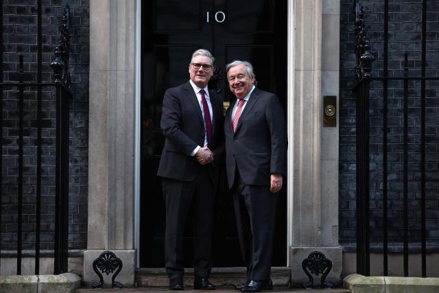 United Nations Secretary-General Antonio Guterres (R) shakes hands with Britain's Prime Minister Keir Starmer (L) outside 10 Downing Street in central London on January 16, 2026, ahead of talks. (Photo by HENRY NICHOLLS / POOL / AFP)