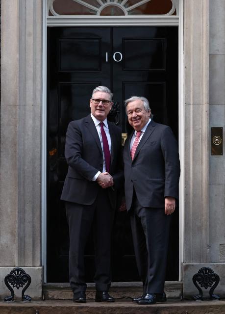 United Nations Secretary-General Antonio Guterres (R) shakes hands with Britain's Prime Minister Keir Starmer (L) outside 10 Downing Street in central London on January 16, 2026, ahead of talks. (Photo by HENRY NICHOLLS / POOL / AFP)