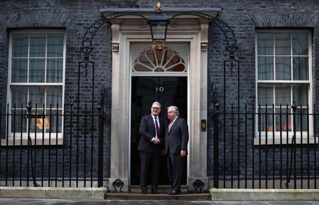 United Nations Secretary-General Antonio Guterres (R) shakes hands with Britain's Prime Minister Keir Starmer (L) outside 10 Downing Street in central London on January 16, 2026, ahead of talks. (Photo by HENRY NICHOLLS / POOL / AFP)