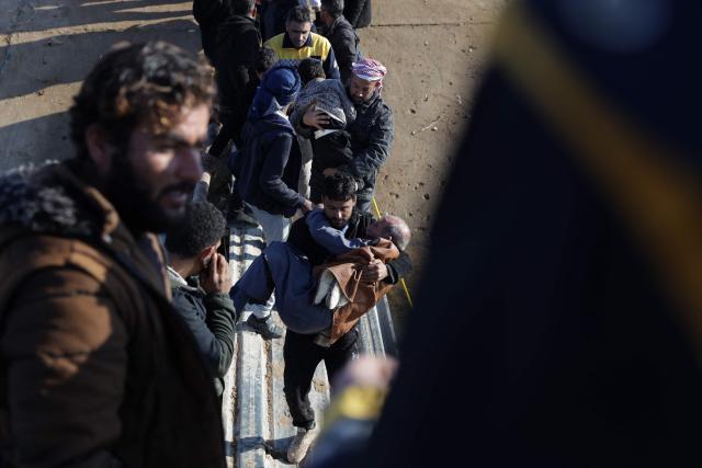 People walk across a damaged bridge as they flee from a Kurdish-controlled area, in Rasm al-Harmal, east of Aleppo city on January 16, 2026. Civilians fled a Kurdish-held region of northern Syria on January 16 before a deadline set by the army, which seeks to expand its control over the area after driving Kurdish forces from Aleppo. The government is seeking to extend its authority nationwide following the ousting of longtime leader Bashar al-Assad in December 2024. (Photo by Bakr ALkasem / AFP)