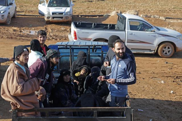 People wait to flee in a vehicle from a Kurdish-controlled area, in Rasm al-Harmal, east of Aleppo city on January 16, 2026. Civilians fled a Kurdish-held region of northern Syria on January 16 before a deadline set by the army, which seeks to expand its control over the area after driving Kurdish forces from Aleppo. The government is seeking to extend its authority nationwide following the ousting of longtime leader Bashar al-Assad in December 2024. (Photo by Bakr ALkasem / AFP)