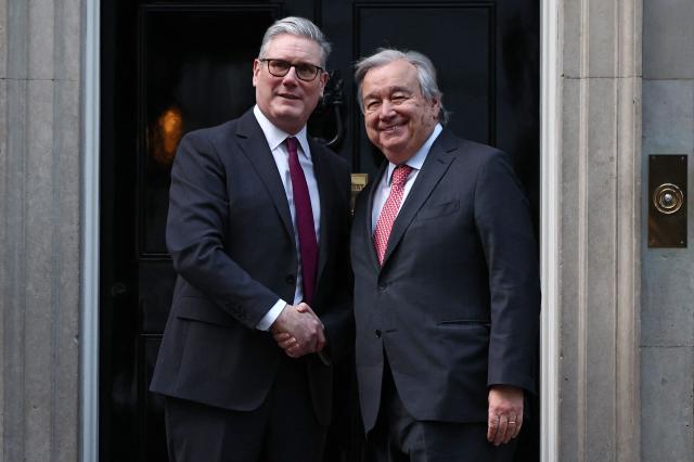 United Nations Secretary-General Antonio Guterres (R) is greeted by Britain's Prime Minister Keir Starmer outside 10 Downing Street in central London on January 16, 2026, ahead of talks. (Photo by HENRY NICHOLLS / POOL / AFP)