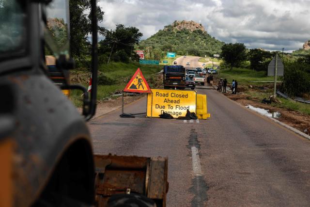 A general view of a sign indicating a closed road leading into Phalaborwa on January 16, 2026 following heavy rains over much of the Limpopo Province, South Africa. Heavy rains have drenched the northeast of the country since late last year, claiming at least 30 lives, with the region on maximum alert for more rain in the coming days. (Photo by Paul Botes / AFP)