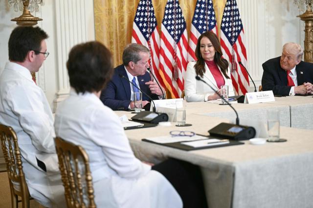 (L/R) Nebraska Governor Jim Pillen speaks as US Secretary of Agriculture Brooke Rollins and US President Donald Trump look on during a roundtable discussion on rural health care investments in the East Room of the White House in Washington, DC on January 16, 2026. (Photo by Brendan SMIALOWSKI / AFP)