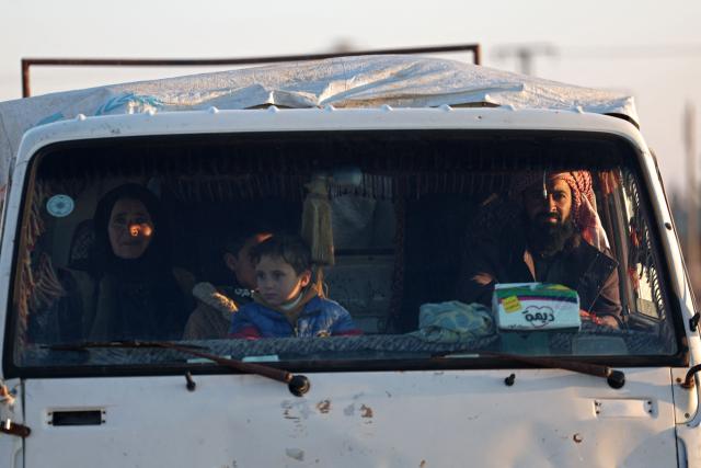 A family flees in a vehicle from the vicinity of the Humaymah village, east of Aleppo city on January 16, 2026. Civilians fled a Kurdish-held region of northern Syria on January 16 before a deadline set by the army, which seeks to expand its control over the area after driving Kurdish forces from Aleppo. The government is seeking to extend its authority nationwide following the ousting of longtime leader Bashar al-Assad in December 2024. (Photo by OMAR HAJ KADOUR / AFP)