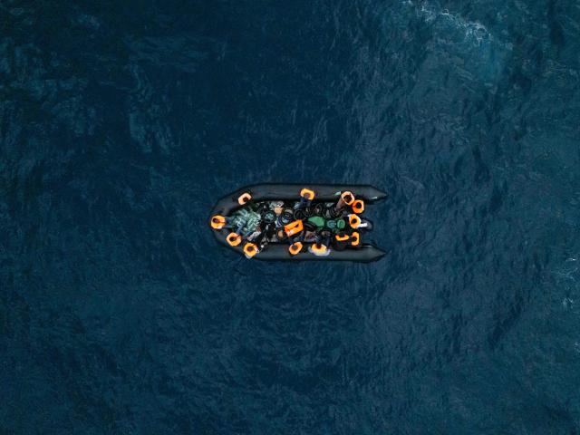 This aerial photograph shows a boat carrying migrants in destress as they await rescue from the “Ocean Viking” rescue ship, in the search-and-rescue zone off the international waters of Libya on January 16, 2026. 47 migrants on a rubber dinghy in distress were rescued by the crew of the "Ocean Viking" in international waters off the coast of Libya as they attempted to reach the shores of the Italian island of Lampedusa. Libya, located about 300 km from the Italian coast, is one of the main departure points in North Africa for migrants, mostly from sub-Saharan Africa, risking their lives attempting to cross the Mediterranean sea. This is the first rescue of the year carried out by the ship operated by the NGO SOS Mediterranee. (Photo by Sameer Al-DOUMY / AFP)