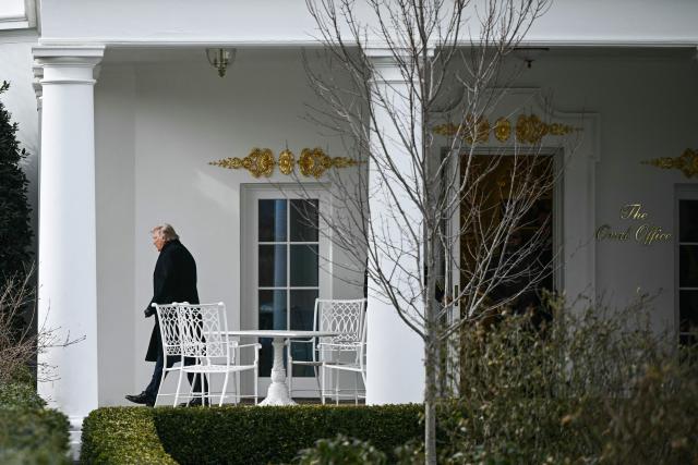 US President Donald Trump exits the Oval Office as he walks to board Marine One on the South Lawn of the White House in Washington, DC, on January 16, 2026. Trump is travelling to Palm Beach, Florida, to spend the weekend at his Mar-a-Lago residence. (Photo by Brendan SMIALOWSKI / AFP)