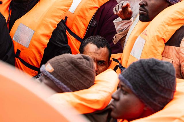 Migrants wait onboard a rubber boat as crew members of the “Ocean Viking” rescue ship carry out a rescue operation in the search-and-rescue zone off the international waters of Libya, on January 16, 2026. 46 migrants on a rubber dinghy in distress were rescued by the crew of the "Ocean Viking" in international waters off the coast of Libya as they attempted to reach the shores of the Italian island of Lampedusa. Libya, located about 300 km from the Italian coast, is one of the main departure points in North Africa for migrants, mostly from sub-Saharan Africa, risking their lives attempting to cross the Mediterranean sea. This is the first rescue of the year carried out by the ship operated by the NGO SOS Mediterranee. (Photo by Sameer Al-DOUMY / AFP)