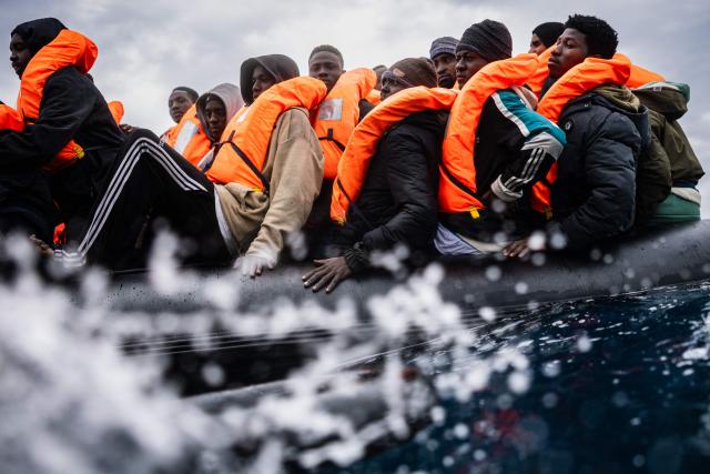 Migrants onboard crowded rubber boat wait as crew members of the “Ocean Viking” rescue ship carry out a rescue operation in the search-and-rescue zone off the international waters of Libya, on January 16, 2026. 46 migrants on a rubber dinghy in distress were rescued by the crew of the "Ocean Viking" in international waters off the coast of Libya as they attempted to reach the shores of the Italian island of Lampedusa. Libya, located about 300 km from the Italian coast, is one of the main departure points in North Africa for migrants, mostly from sub-Saharan Africa, risking their lives attempting to cross the Mediterranean sea. This is the first rescue of the year carried out by the ship operated by the NGO SOS Mediterranee. (Photo by Sameer Al-DOUMY / AFP)