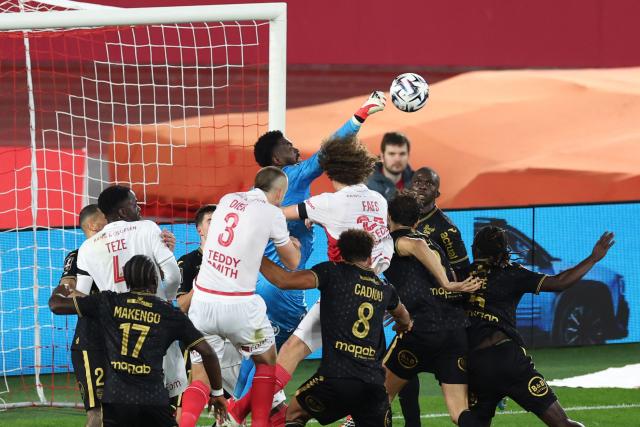 Lorient's Swiss goalkeeper #38 Yvon Mvogo clears the ball during the French L1 football match between AS Monaco and FC Lorient at the Stade Louis II in the Principality of Monaco on January 16, 2026. (Photo by Valery HACHE / AFP)