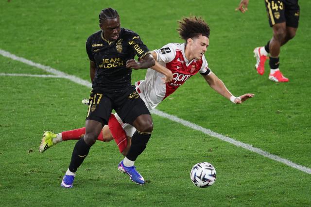 Lorient's French midfielder #17 Jean-Victor Makengo (L) fights for the ball with Monaco's French midfielder #11 Maghnes Akliouche (R) during the French L1 football match between AS Monaco and FC Lorient at the Stade Louis II in the Principality of Monaco on January 16, 2026. (Photo by Valery HACHE / AFP)