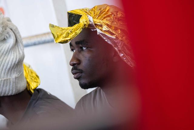 A migrant sits onboard of the “Ocean Viking” rescue ship after being rescued in the search-and-rescue zone off the international waters of Libya, on January 16, 2026. 46 migrants on a rubber dinghy in distress were rescued by the crew of the "Ocean Viking" in international waters off the coast of Libya as they attempted to reach the shores of the Italian island of Lampedusa. Libya, located about 300 km from the Italian coast, is one of the main departure points in North Africa for migrants, mostly from sub-Saharan Africa, risking their lives attempting to cross the Mediterranean sea. This is the first rescue of the year carried out by the ship operated by the NGO SOS Mediterranee. (Photo by Sameer Al-DOUMY / AFP)