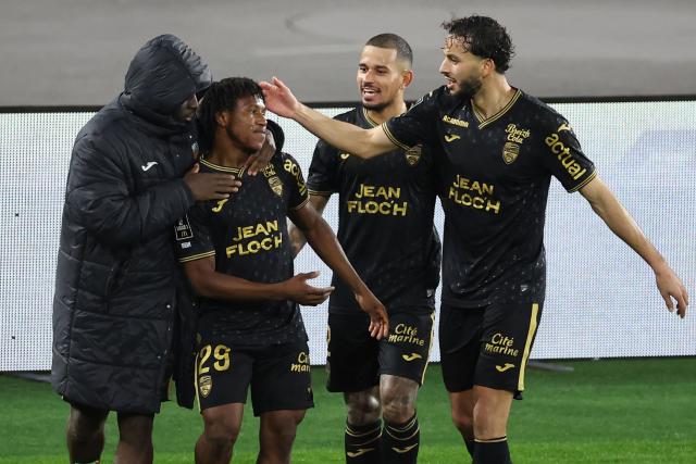 Lorient's Togolese midfielder #29 Dermane Karim (2L) celebrates scoring his team's third goal during the French L1 football match between AS Monaco and FC Lorient at the Stade Louis II in the Principality of Monaco on January 16, 2026. (Photo by Valery HACHE / AFP)