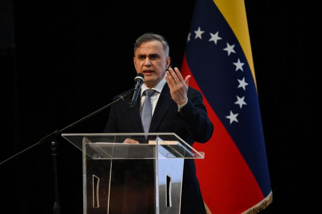 Venezuela's Attorney General Tarek William Saab speaks during a forum organized by the "Network of Lawyers for the Release of President Nicolas Maduro and First Lady Cilia Flores" at the Teresa Carreno Theater in Caracas on January 16, 2026. US Central Intelligence Agency chief John Ratcliffe met Venezuela's interim leader Delcy Rodriguez in Caracas on January 15, a US administration official said, in the highest-level American visit since the fall of Nicolas Maduro. (Photo by Federico PARRA / AFP)