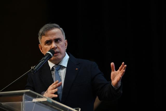 Venezuela's Attorney General Tarek William Saab speaks during a forum organized by the "Network of Lawyers for the Release of President Nicolas Maduro and First Lady Cilia Flores" at the Teresa Carreno Theater in Caracas on January 16, 2026. US Central Intelligence Agency chief John Ratcliffe met Venezuela's interim leader Delcy Rodriguez in Caracas on January 15, a US administration official said, in the highest-level American visit since the fall of Nicolas Maduro. (Photo by Federico PARRA / AFP)