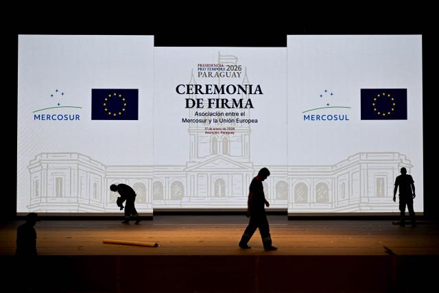 Workers set up the stage for the signing ceremony of the agreement between the European Union and Mercosur at the Gran Teatro Jose Asuncion Flores of Paraguay's Central Bank in Asuncion on January 16, 2026. The South American bloc Mercosur and the European Union will sign a deal on January 17, 2026, 25 years in the making, to create one of the world's biggest free trade areas at a time of growing protectionism and volatility. (Photo by Luis ROBAYO / AFP)