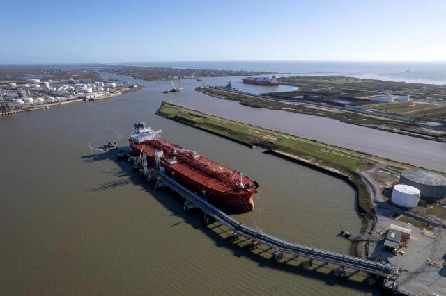 An aerial photo shows the Nave Photon crude oil tanker, carrying a shipment of Venezuelan oil, docked in Freeport, Texas, on January 16, 2026. The United States has finalized a sale of Venezuelan oil — the first since Washington took control of the sector following the toppling of president Nicolas Maduro, a US official told AFP on January 15. According to the official, who did not identify the buyer, the deal is worth $500 million, and additional sales could take place in the coming days or weeks. (Photo by Mark Felix / AFP)
