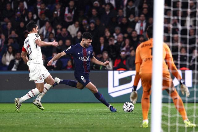 Paris Saint-Germain's Portuguese forward #09 Goncalo Ramos (C) shoots towards goal during the French L1 football match between Paris Saint-Germain (PSG) and Lille LOSC at the Parc des Princes stadium in Paris on January 16, 2026. (Photo by Anne-Christine POUJOULAT / AFP)