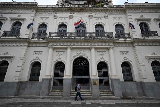 A man walks past the Paraguay's Foreign Ministry building in Asuncion on January 16, 2026. (Photo by Luis ROBAYO / AFP)