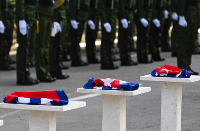 Cuban flags are pictured during the funeral of the 32 Cuban soldiers killed during the US incursion in Venezuela at Colon cemetery in Havana on January 16, 2026. The capture by US forces of Venezuelan leader Nicolas Maduro on January 3, 2026, and the killing in the operation of 32 Cubans assigned to protect him represent a major blow for the island's revered intelligence services, experts say. (Photo by ADALBERTO ROQUE / AFP)