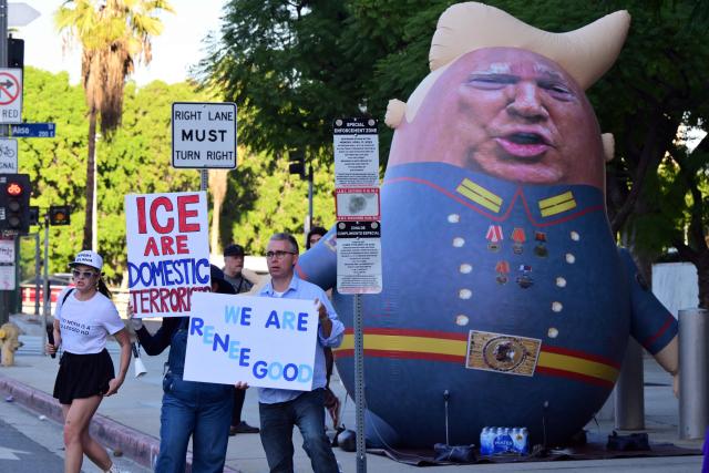 A 15-foot-tall balloon, depicting US President Donald Trump wearing a Russian military uniform, is displayed during a protest against ICE and Trump's immigration crackdown outside the Federal Building in Los Angeles, California on January 16, 2026. (Photo by Frederic J. Brown / AFP)
