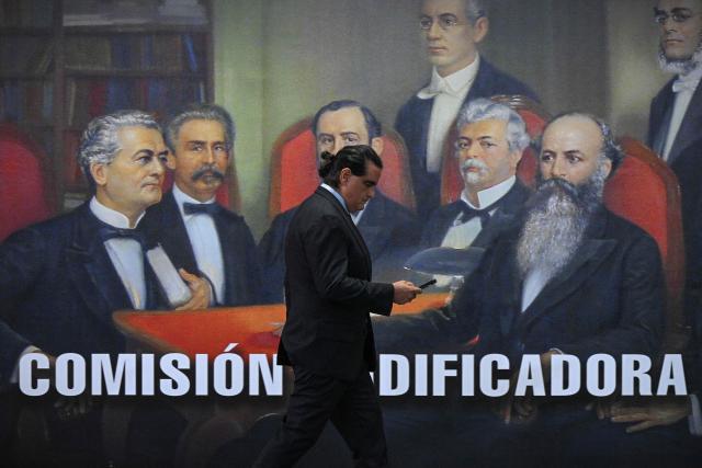 (FILES) Colombian-born businessman Alex Saab uses his mobile phone as he waits for Venezuelan President Nicolas Maduro at Venezuela's Supreme Court of Justice in Caracas on July 31, 2024. Venezuela's interim President Delcy Rodriguez dismissed Colombian businessman Alex Saab from his post of Minister of Industry on January 16, 2025. Saab has been accused of being a front man for the deposed President Nicolas Maduro. The change comes amid pressure from Washington following the attacks on January 3. (Photo by Federico PARRA / AFP)