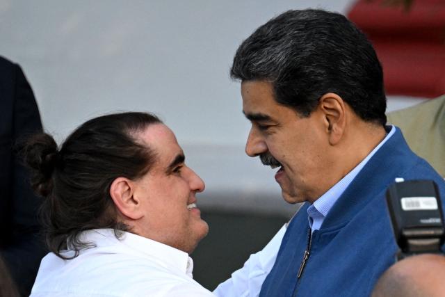 (FILES) Venezuela's President Nicolas Maduro (R) welcomes Colombian businessman Alex Saab at the Miraflores Presidential Palace in Caracas on December 20, 2023. Venezuela's interim President Delcy Rodriguez dismissed Colombian businessman Alex Saab from his post of Minister of Industry on January 16, 2025. Saab has been accused of being a front man for the deposed President Nicolas Maduro. The change comes amid pressure from Washington following the attacks on January 3. (Photo by Federico Parra / AFP)