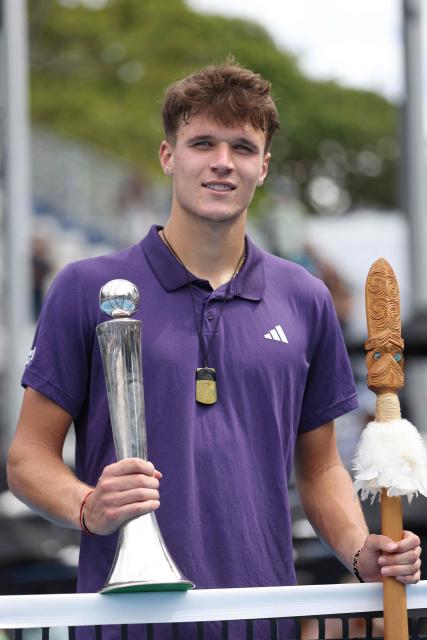 Czech Republic's Jakub Mensik poses with his trophy after victory against Argentina's Sebastian Baez in their men's singles final match at the ATP Auckland Classic tennis tournament in Auckland on January 17, 2026. (Photo by Michael Bradley / AFP)
