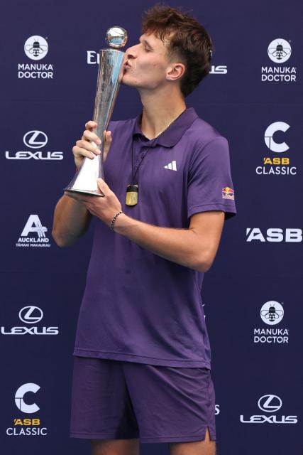 Czech Republic's Jakub Mensik poses with his trophy after victory against Argentina's Sebastian Baez in their men's singles final match at the ATP Auckland Classic tennis tournament in Auckland on January 17, 2026. (Photo by Michael Bradley / AFP)