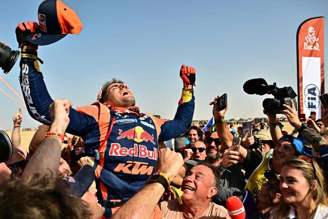 Argentine rider Luciano Benavides with a Ktm 450 Rally Factory celebrates after winning the 48th edition of the Dakar Rally 2026 in Yanbu, Saudi Arabia, on January 17, 2026. (Photo by Giuseppe CACACE / AFP)