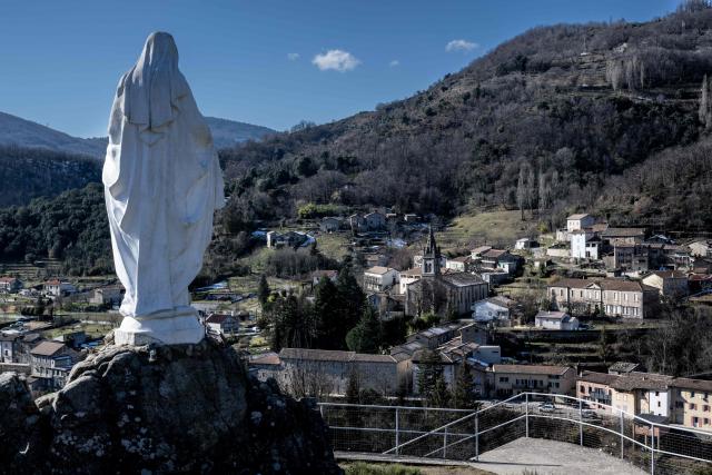 (FILES) This photograph taken on February 8, 2023, shows the statue of the Virgin Mary which dominates the village of Saint-Pierre-de-Colombier, southern France, where a religious community, the Missionary Family of Notre Dame, has the ambition to build a new church for the thousands of faithful who come on pilgrimage a few days a year. A traditionalist Catholic community in Ardeche and its leader, Father Bernard, goes on trial from January 19, 2026, in Privas for "abuse of weakness" against former members, who say they were isolated, worn out and bullied after joining. The Missionary Family of Our Lady (FMND), which has around 150 members, both men and women, in Saint-Pierre-de-Colombier and 14 other centres, "vigorously contests" the accusations of sectarian abuse levelled against it, its spokesperson, Brother Clement-Marie Domini, told AFP. (Photo by JEAN-PHILIPPE KSIAZEK / AFP)