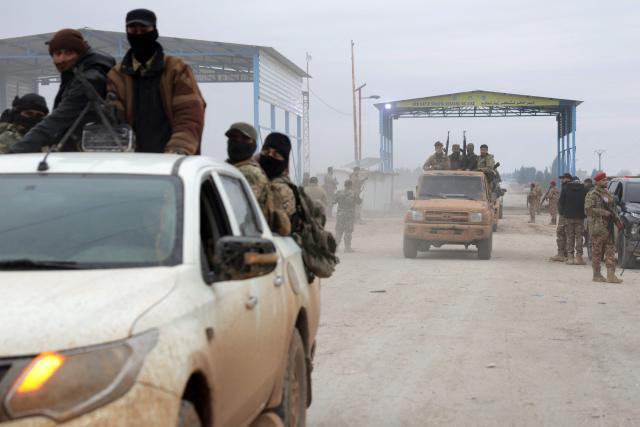 TOPSHOT - Syrian army soldiers in their vehicles enter the Deir Hafer town on January 17, 2026. Syria's army said it took control of the town of Deir Hafer outside Aleppo city on January 17, a day after Kurdish forces agreed to withdraw from the area following recent clashes. In a statement to state television, the army said it had established "full military control" of Deir Hafer, while an AFP correspondent on the ground saw troops deploying inside the town. (Photo by Bakr ALkasem / AFP)