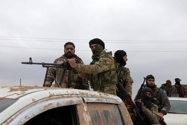 Syrian army soldiers in their vehicles enter the Deir Hafer town on January 17, 2026. Syria's army said it took control of the town of Deir Hafer outside Aleppo city on January 17, a day after Kurdish forces agreed to withdraw from the area following recent clashes. In a statement to state television, the army said it had established "full military control" of Deir Hafer, while an AFP correspondent on the ground saw troops deploying inside the town. (Photo by Bakr ALkasem / AFP)